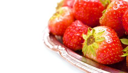 strawberry on silver plate over white background