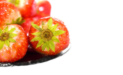 strawberry on silver plate over white background