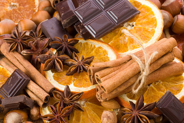 Sliced dried orange with cinnamon sticks chocolate and anise