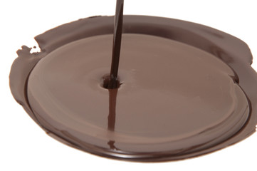 Chocolate flow isolated on white background close up