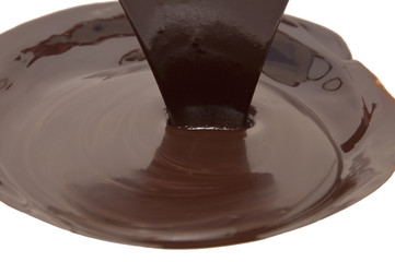 Chocolate flow isolated on white background close up