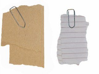 paper scraps and paperclip isolated on white