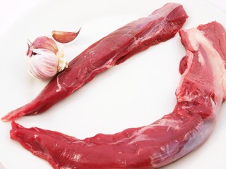 Raw meat towards bright background with garlic