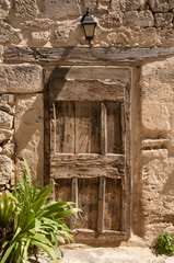 Wooden door in the old brick wall