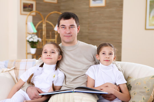 father with his daughters at home