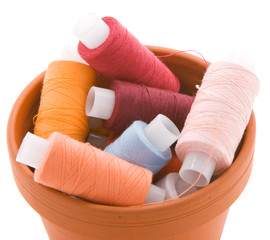 Container full of spools with thread
