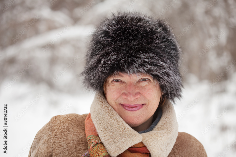 Wall mural of mature woman in wintry forest