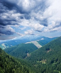 Fototapeta na wymiar dense clouds above a mountain valley