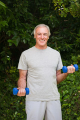 Senior man doing his exercises in the garden