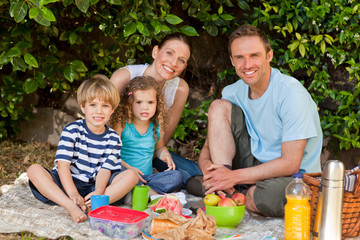 Happy family picnicking in the garden