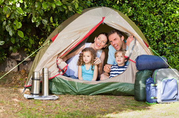 Joyful family camping in the garden