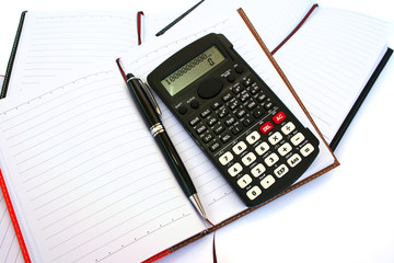 Calculator, pen and notebooks