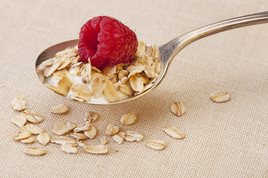 spoon of cereal with raspberry