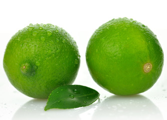Limes with leaf on a white background