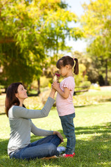 Fototapeta premium Joyful mother with her daughter in the park