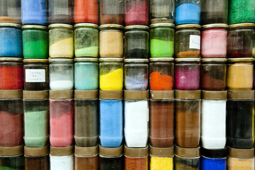 Jars of Powdered Dye Stacked in a Storefront
