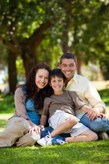 Fototapeta premium Joyful family sitting in the garden
