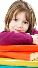 Beautiful girl with school books on the table.