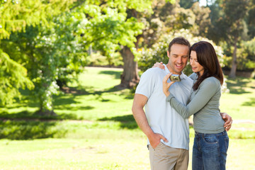 Fototapeta premium Radiant couple hugging in the park