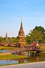 Fototapeta na wymiar Ancient pagoda in Ayutthaya with lake vertical