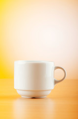 White cup against colourful gradient on the table