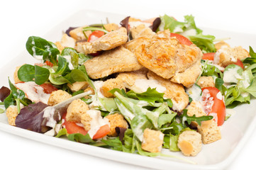 Ceasar salad on a plate isolated on white