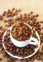 Cup filled with coffee beans