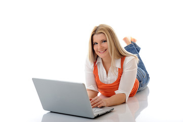 Young pretty girl networking on laptop computer in internet. iso