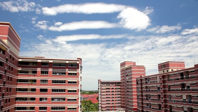 Clouds flloating by HDB and terrace house
