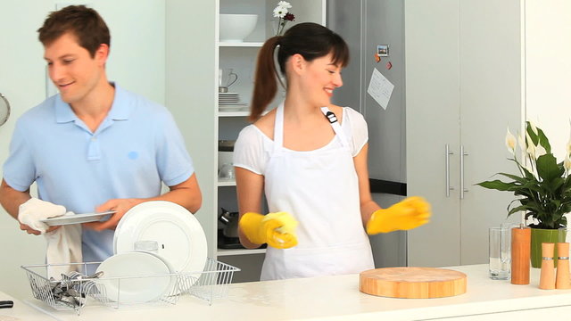 Cute couple washing up together
