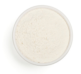 Wheat flour in a plate on white background