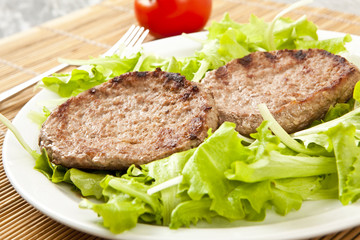 two hamburger on green lettuce