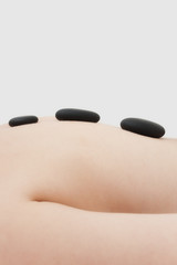 Obraz na płótnie Canvas Hot spa stones on woman's back