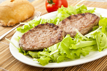 two hamburger on green lettuce