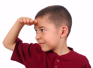 kid looking at a distance with eyes shaded