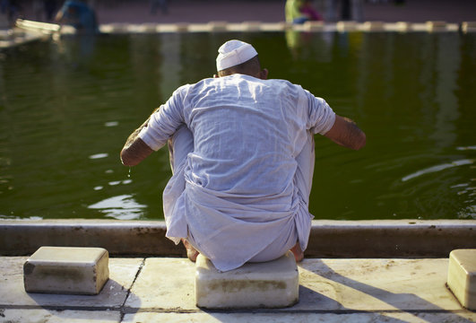 Muslim man performing a wudu before praying