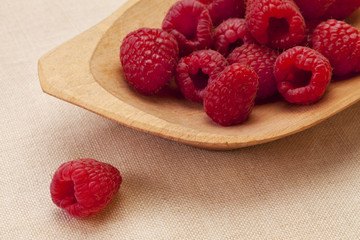 red raspberries in wooden bowl