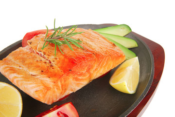 hot baked salmon piece served with vegetables