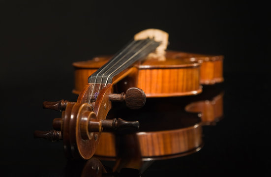 Old violin over black
