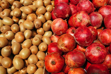 lot of kiwi and pomegranate on counter