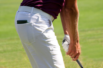Detail of man playing golf