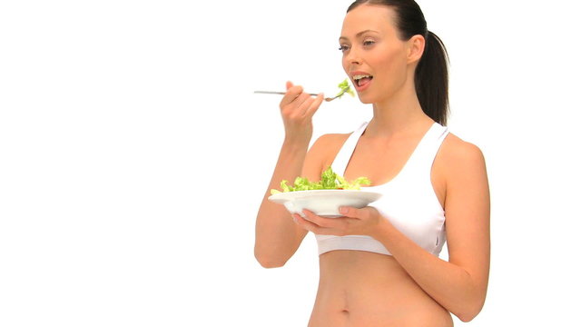 Woman in sportswear eating a salad