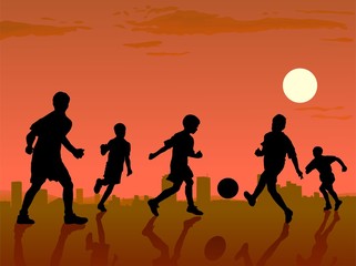 boys playing in soccer on sunset