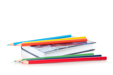 diary and crayons isolated on white