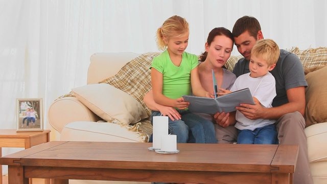 Cute family reading a book