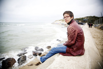 Woman relaxing by the sea in winter