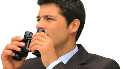 Businessman looking through binoculars