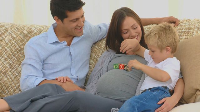 Pregnant woman with her husband and her son