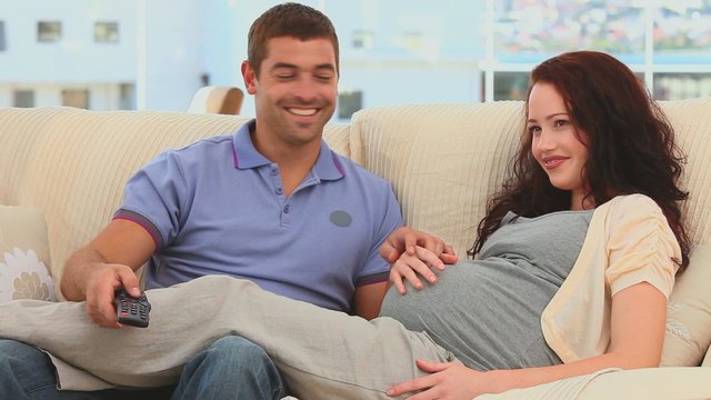 Future parents watching a movie