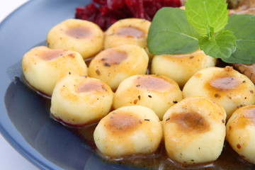 Dumplings with sauce decorated with mint twig
